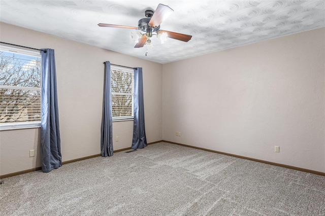 carpeted empty room featuring ceiling fan