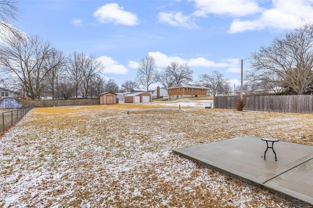 snowy yard with a shed