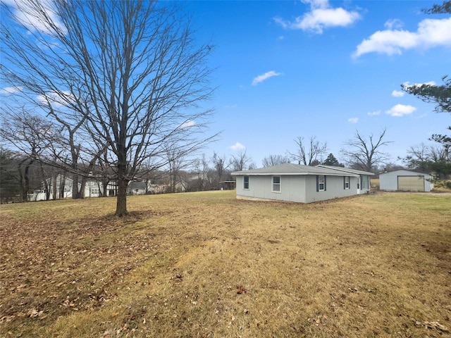 view of yard featuring an outbuilding and a garage