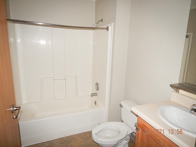 full bathroom featuring washtub / shower combination, tile patterned floors, toilet, and vanity