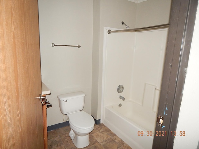 bathroom with shower / bathing tub combination and toilet