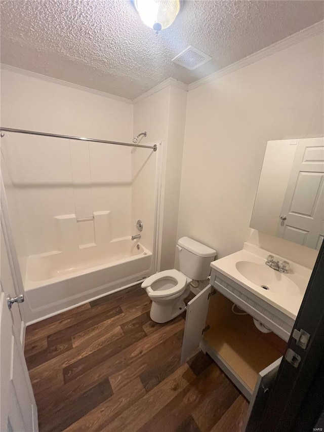 full bathroom with toilet, sink, shower / bathing tub combination, a textured ceiling, and hardwood / wood-style flooring