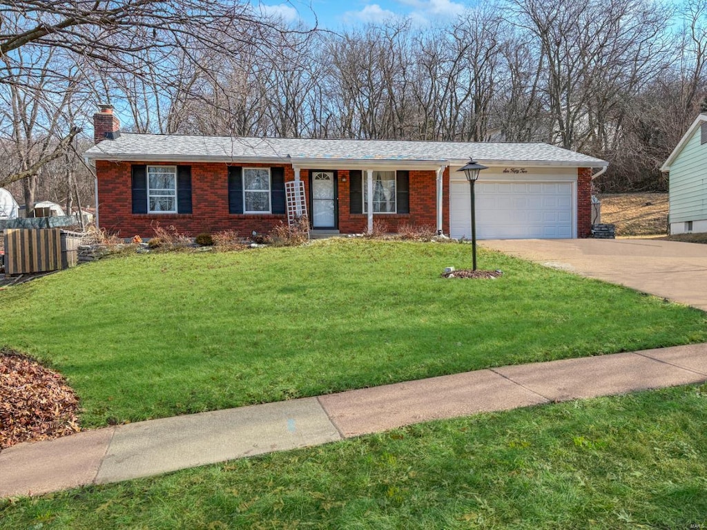 ranch-style home with a garage and a front lawn