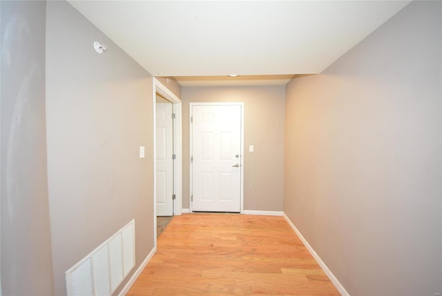 hallway with light hardwood / wood-style floors