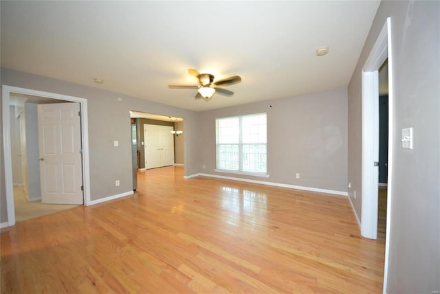 empty room with ceiling fan and light wood-type flooring