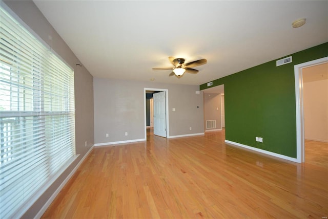 empty room featuring ceiling fan and light hardwood / wood-style flooring