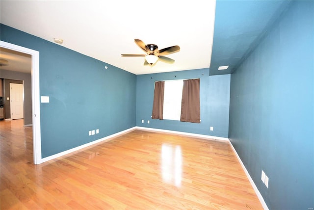 empty room featuring wood-type flooring and ceiling fan