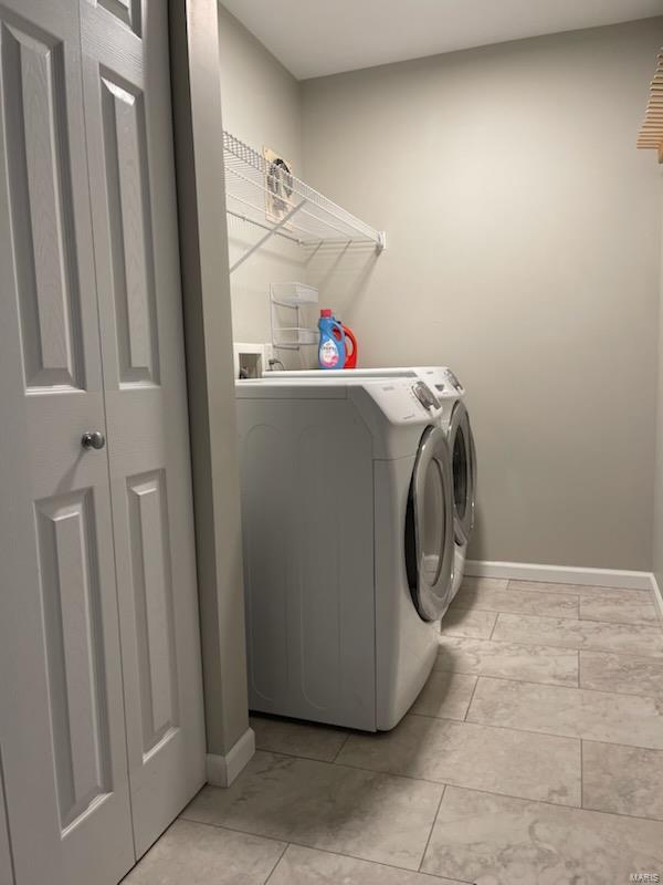 clothes washing area with independent washer and dryer