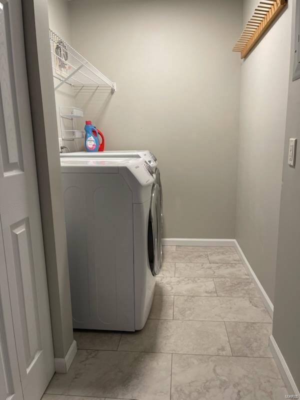 clothes washing area featuring separate washer and dryer