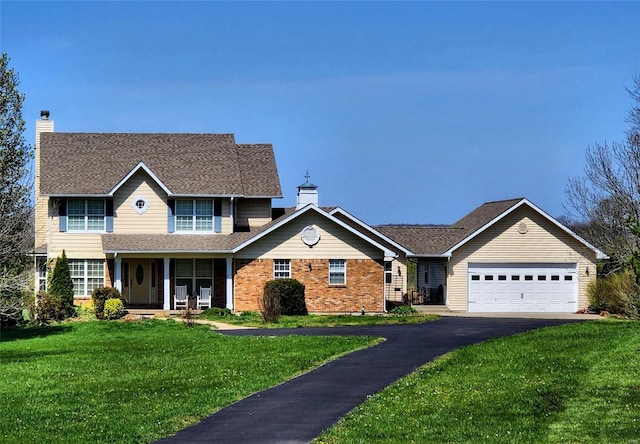 view of front facade featuring a garage, a front yard, and covered porch