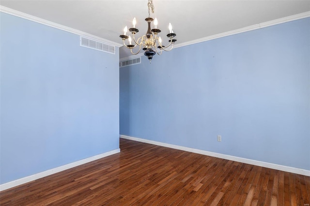 unfurnished room with crown molding, dark hardwood / wood-style floors, and a notable chandelier