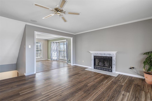 unfurnished living room with hardwood / wood-style flooring, ornamental molding, a premium fireplace, and ceiling fan