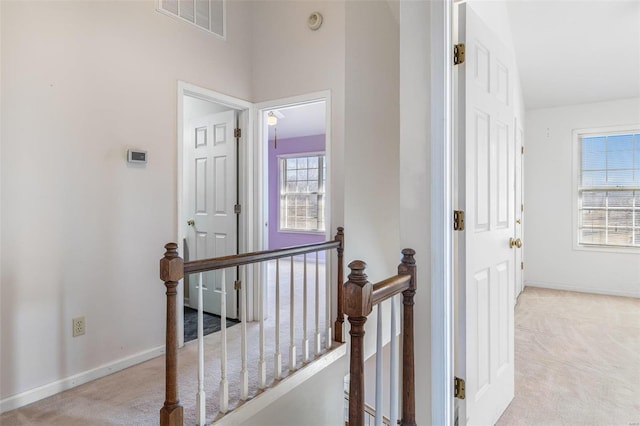 hallway with light colored carpet