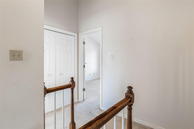 corridor featuring light colored carpet