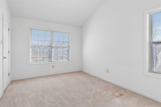 carpeted empty room featuring lofted ceiling and a wealth of natural light