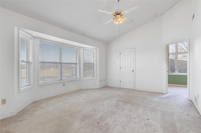 unfurnished bedroom featuring high vaulted ceiling, light colored carpet, and ceiling fan