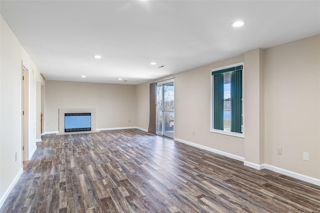 unfurnished living room with dark hardwood / wood-style flooring