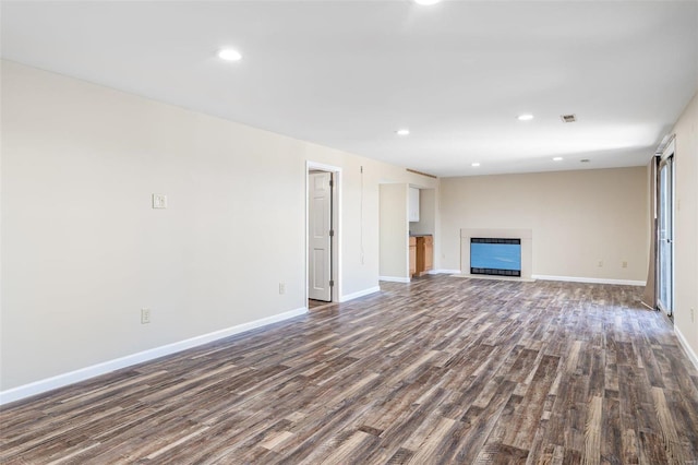 unfurnished living room featuring dark hardwood / wood-style flooring