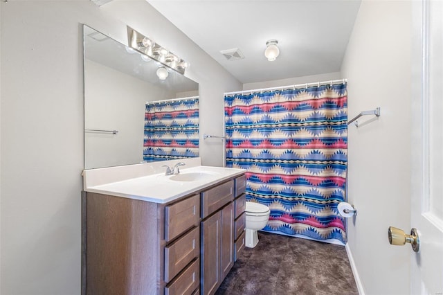 bathroom with vanity, walk in shower, and toilet