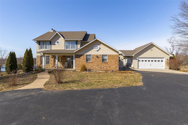 view of front of property featuring a garage and a porch