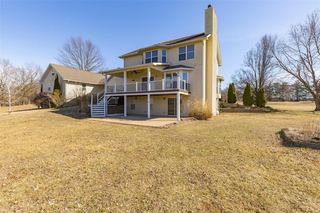 rear view of house with a patio, a yard, and ceiling fan