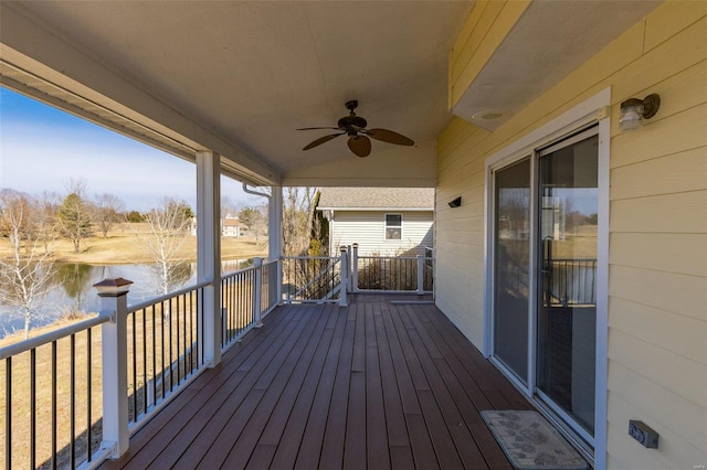 wooden terrace featuring a water view and ceiling fan