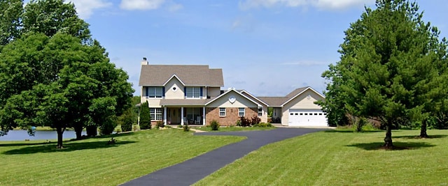 view of front of home featuring a garage and a front lawn