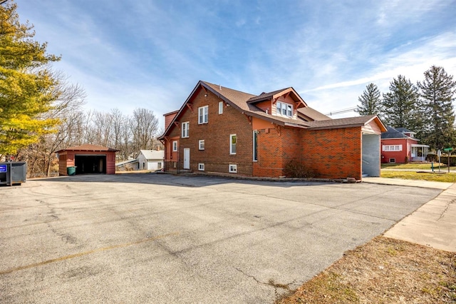 view of home's exterior featuring an outbuilding and a garage