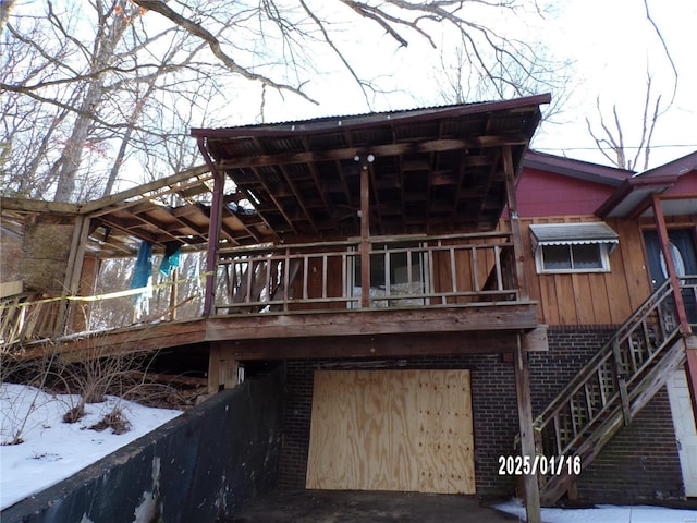 snow covered house featuring a garage