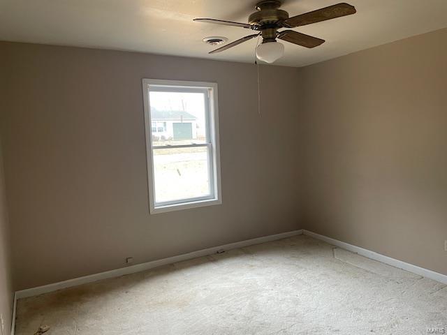 carpeted empty room featuring ceiling fan