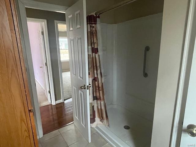 bathroom with tile patterned floors and a shower with shower curtain