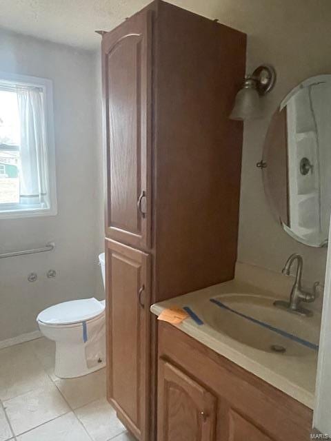 bathroom featuring tile patterned floors, vanity, and toilet