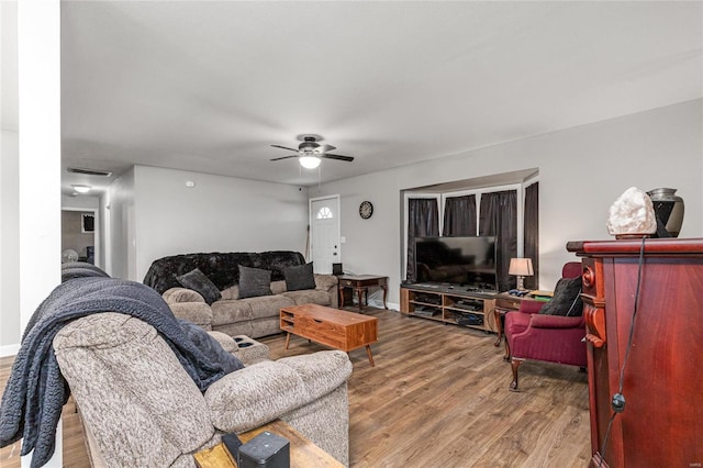 living room featuring ceiling fan and light hardwood / wood-style floors