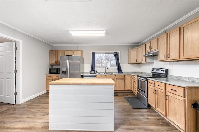 kitchen with hardwood / wood-style flooring, ornamental molding, appliances with stainless steel finishes, and sink