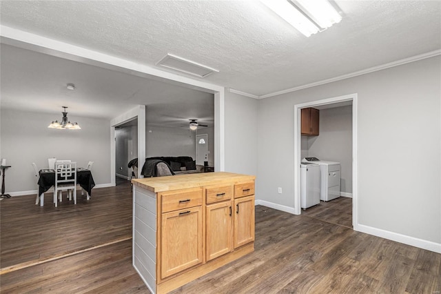 kitchen with independent washer and dryer, dark hardwood / wood-style floors, wooden counters, and a textured ceiling