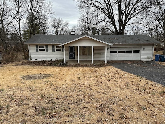 ranch-style home with a garage and a porch