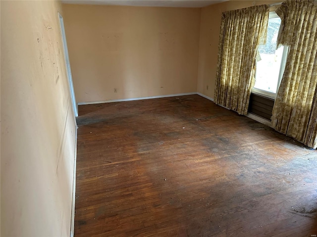 spare room featuring dark wood-type flooring