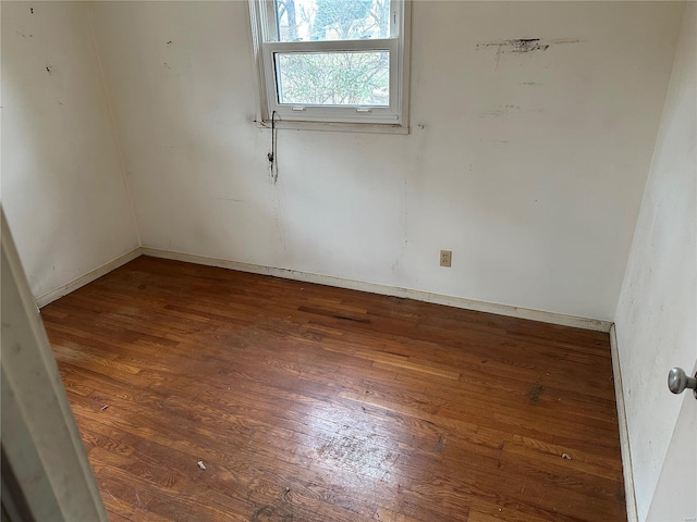 unfurnished room featuring dark hardwood / wood-style flooring