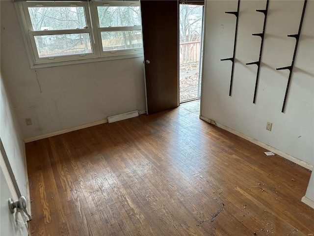 spare room with hardwood / wood-style flooring and a wealth of natural light