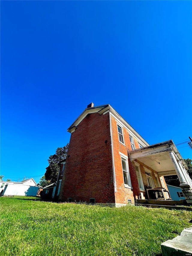 view of property exterior featuring a lawn