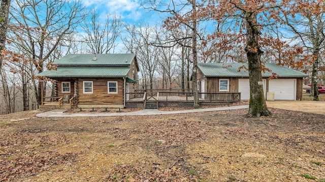 view of front of home with a wooden deck and a garage