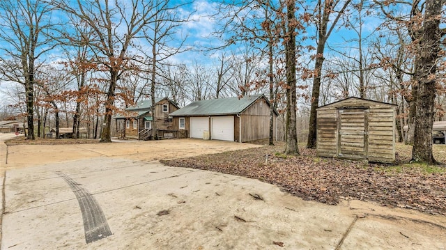 exterior space with a garage and a storage shed