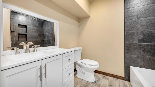 bathroom featuring vanity, hardwood / wood-style flooring, and toilet