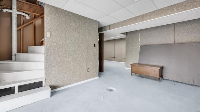 basement featuring a paneled ceiling