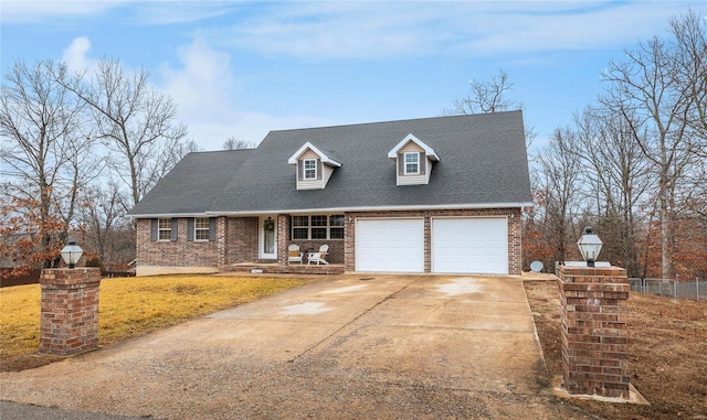 new england style home with a garage and a front lawn