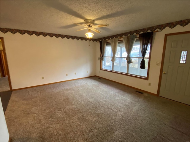 carpeted foyer with ceiling fan and a textured ceiling