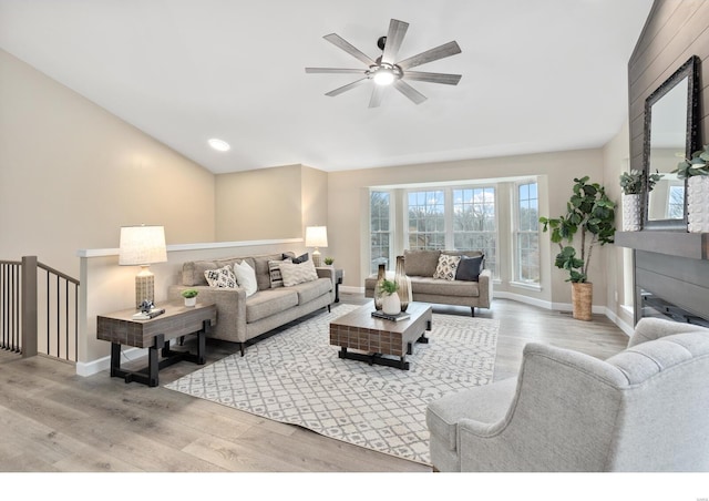 living room with light hardwood / wood-style flooring and ceiling fan