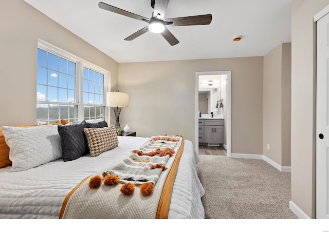 carpeted bedroom featuring ensuite bath and ceiling fan