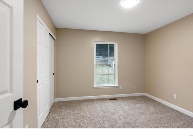 unfurnished bedroom with a closet and carpet