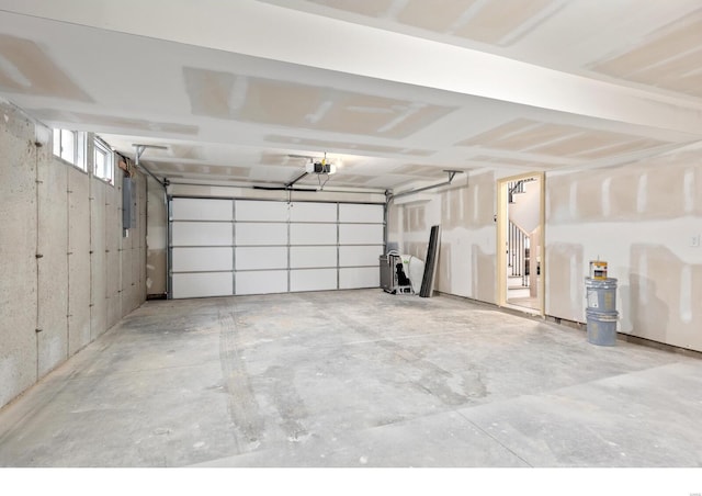 garage featuring a garage door opener and electric panel